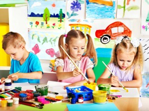 Child painting at easel.